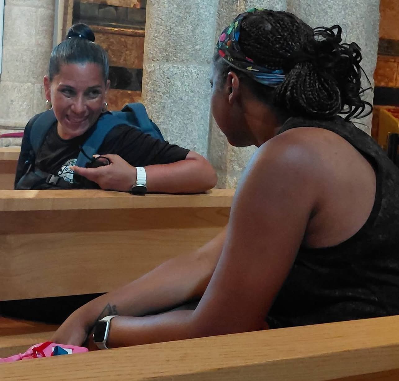 Yasmeen smiling at a fellow pilgrim inside the Cathedral of Santiago